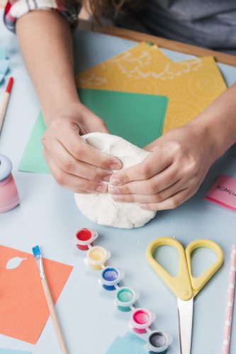 top-view-hand-kneading-white-clay-making-creative-art